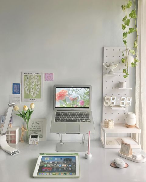 A laptop computer sitting a laptop stand ona neatly organized desk. @lifeofema_