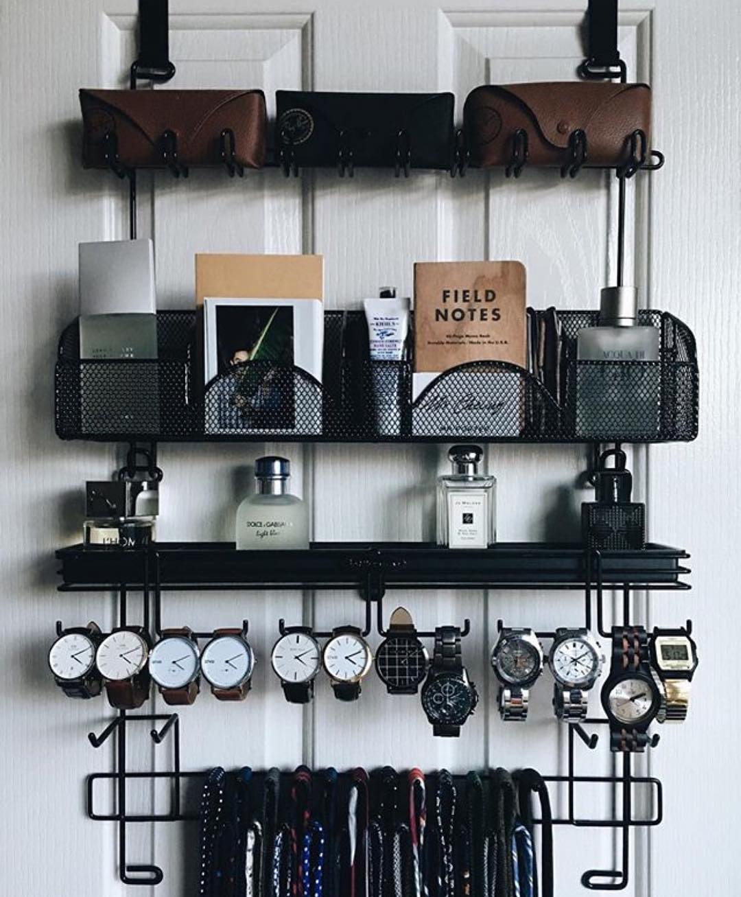 Storage rack on backside of door holding men's accessories. Photo by Instagram user @prismclothingco
