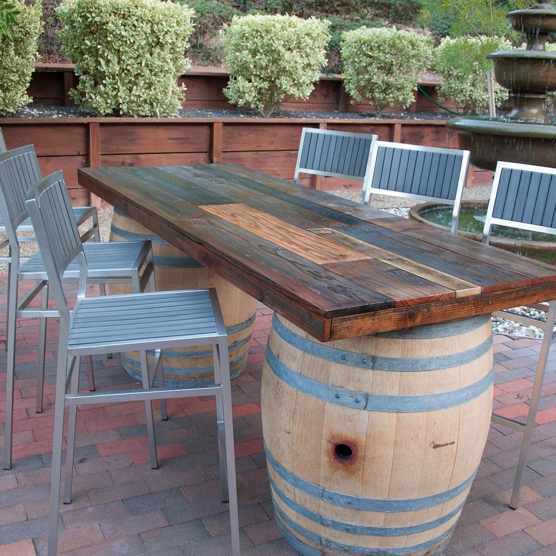 Outdoor table with wine barrels. Photo by Instagram user @urbangardenstudio