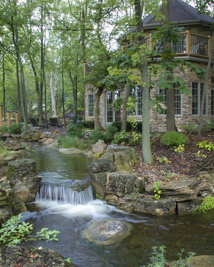 Backyard moat in a wooded area. Photo by Instagram user @aquascape_inc
