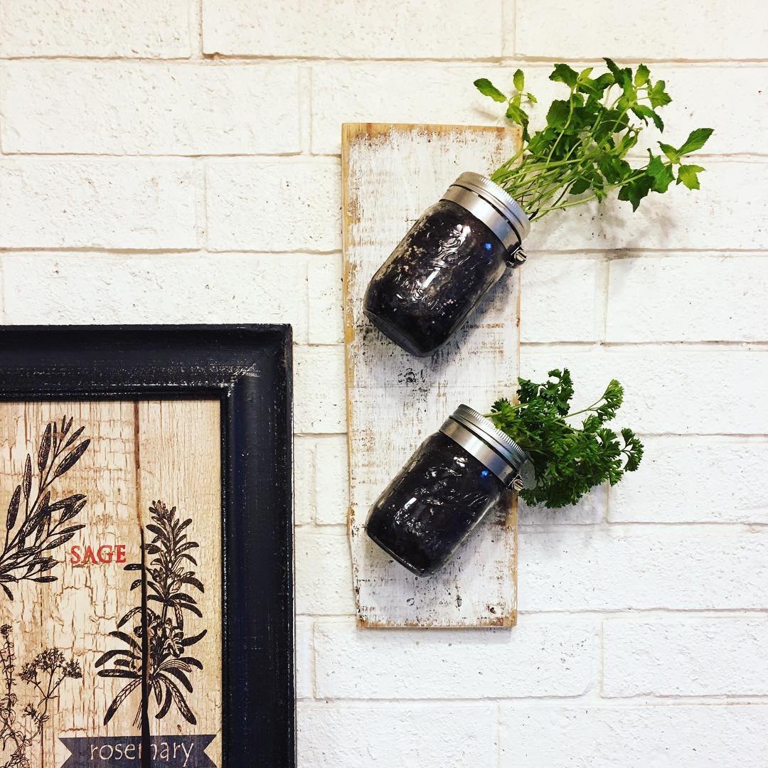 Planters in mason jars on wall. Photo by Instagram user @theweatheredloft