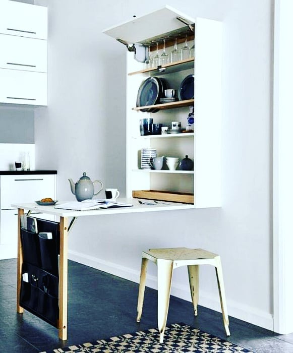 Fold-down table with bench chair in studio apartment. Photo by Instagram user @wallytables