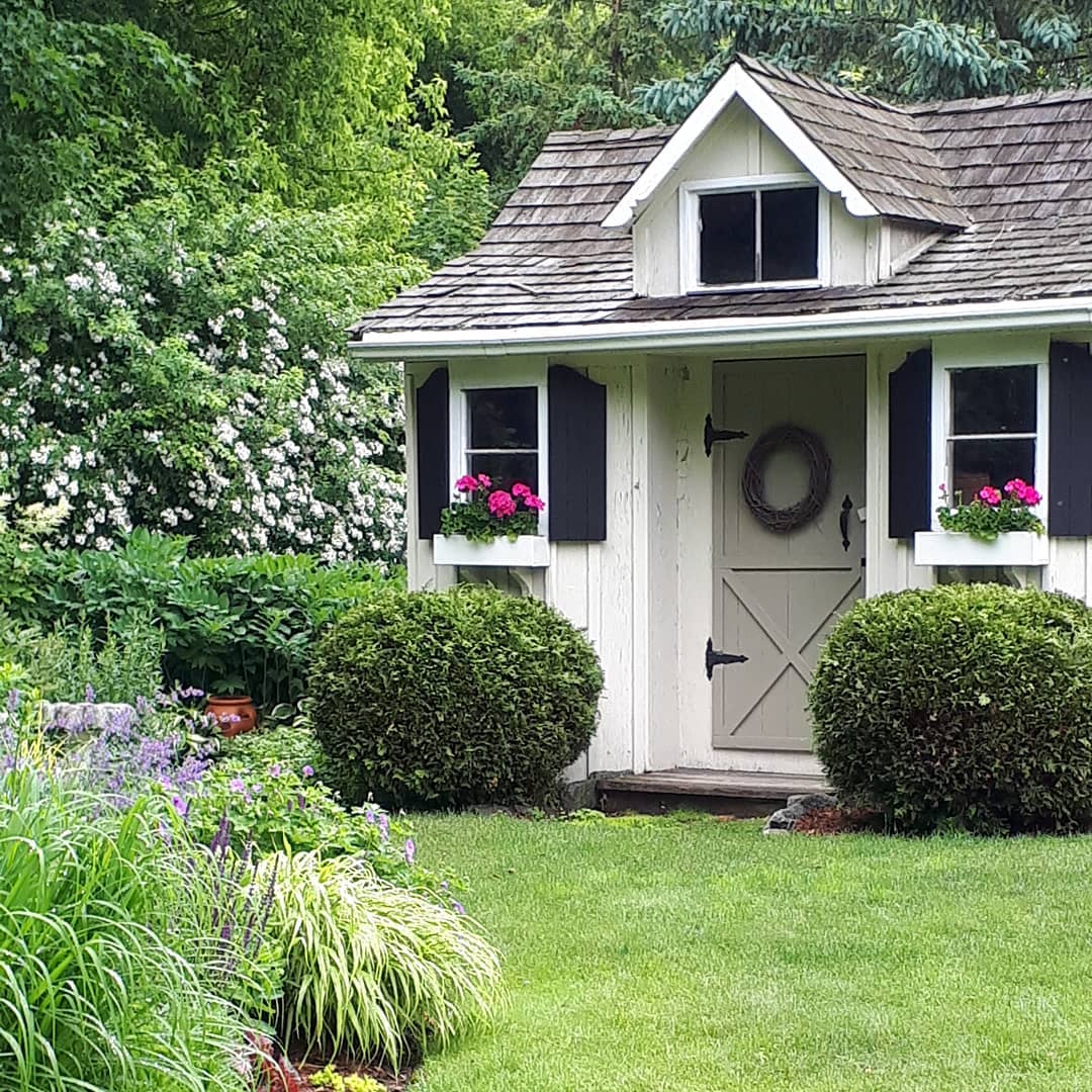 Storage painted white and gray with window planters