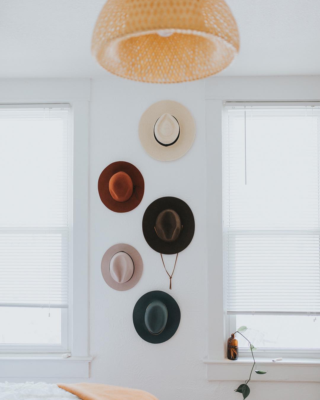 Hipster hats hanging on wall in bedroom. Photo by Instagram user @kaleyfromkansas