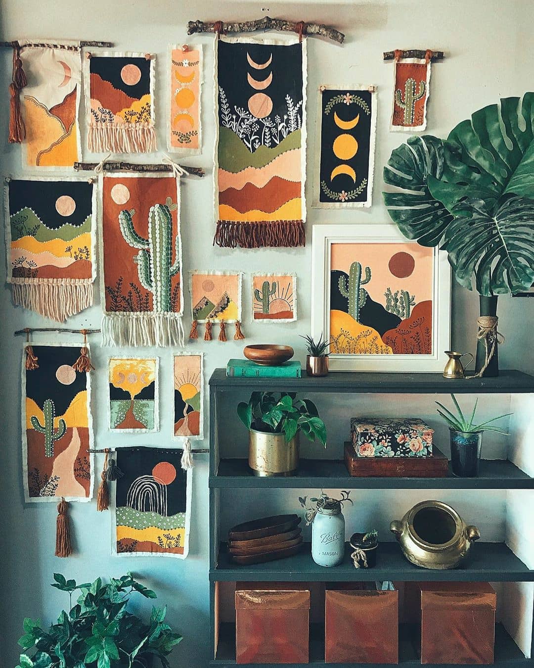 small handmade tapestries hanging on apartment wall photo by Instagram user @graphicolier