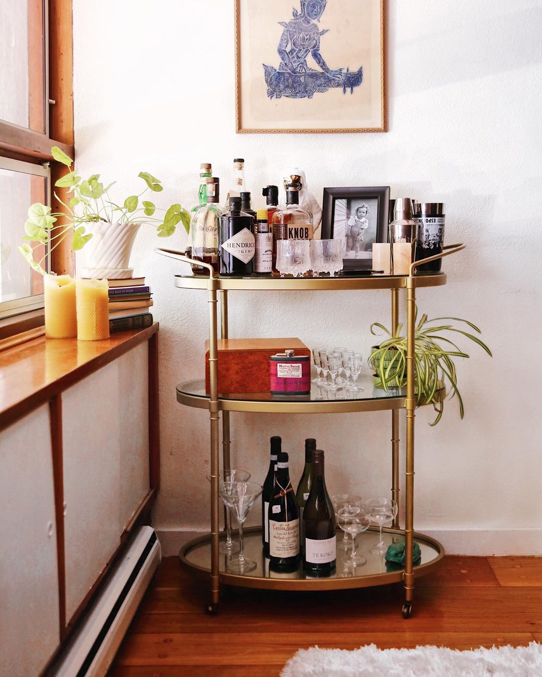 brass bar cart filled with liquor and nice glasses photo by Instagram user @venturetravelist