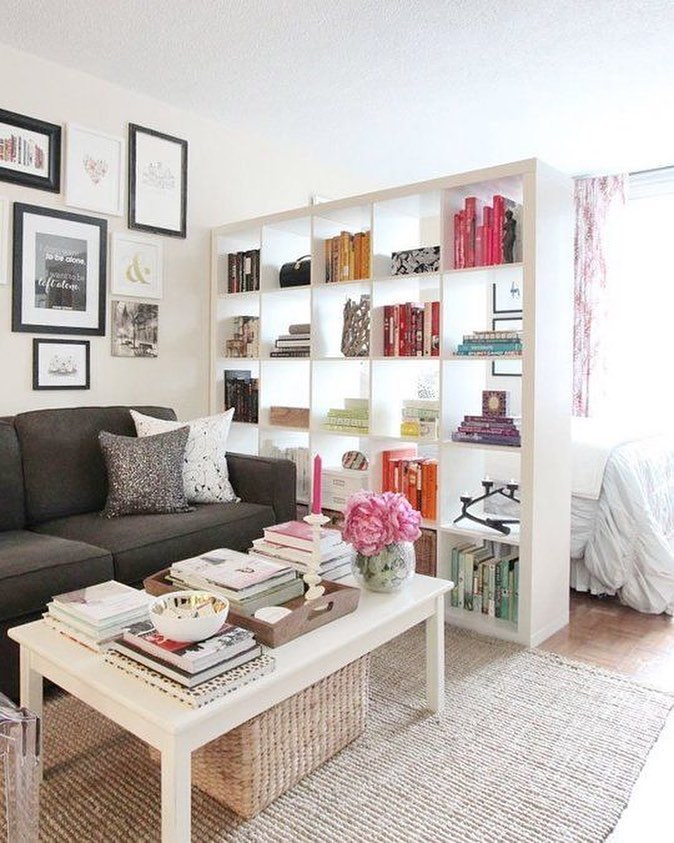 bookshelf used as room separator between bed and living room photo by Instagram user @designreader