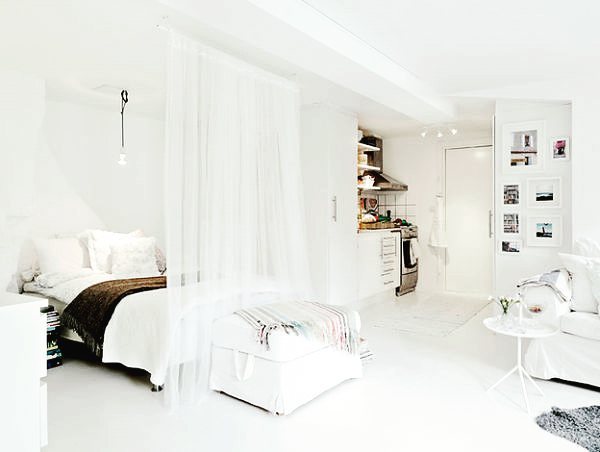 full length white curtain separating bed from living room in small apartment photo by Instagram user @stephomenai
