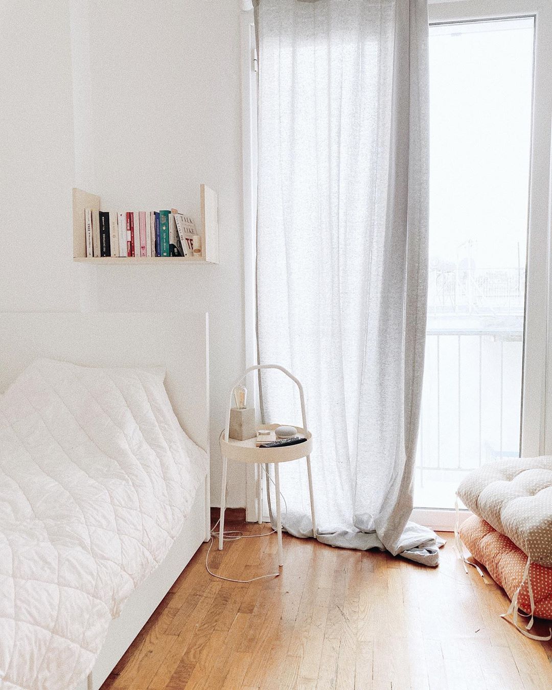 small apartment utilizing long curtains to make the room feel larger photo by Instagram user @josephinemrg