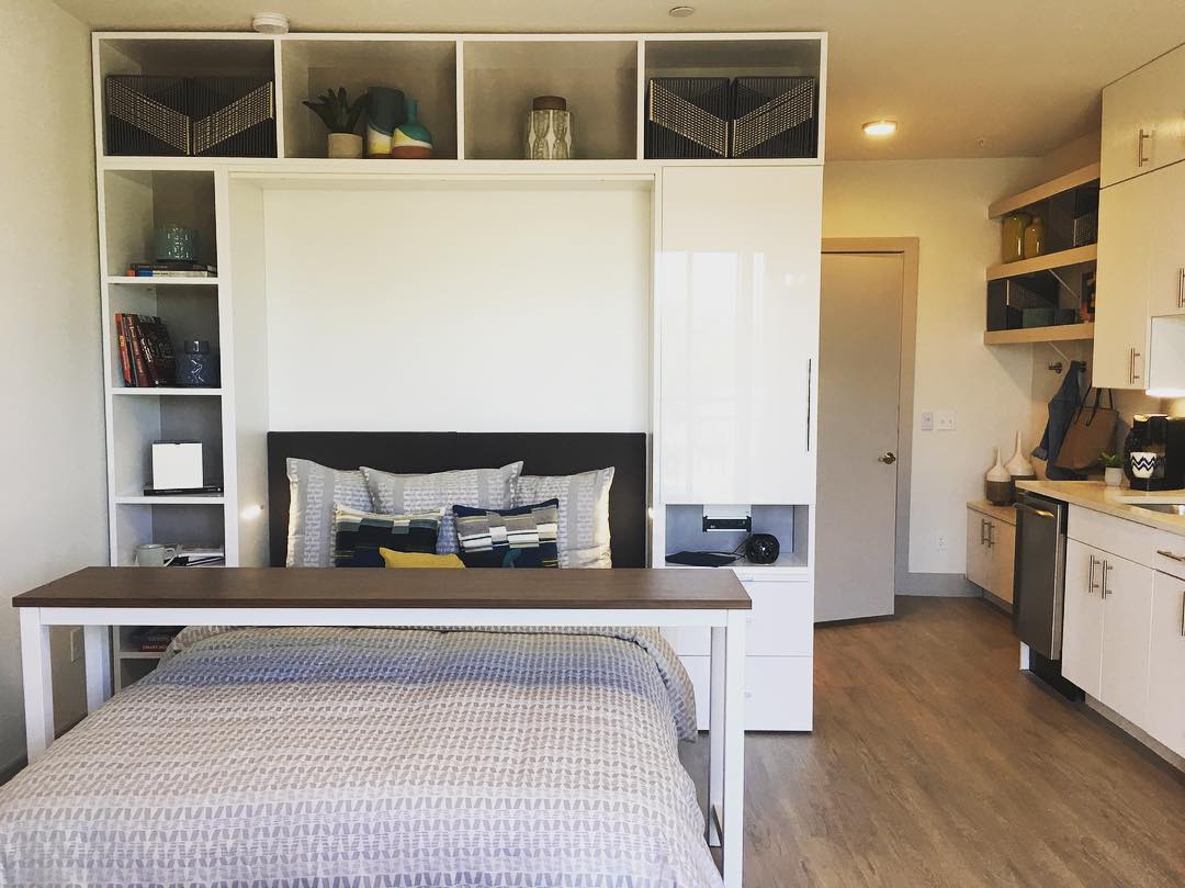 Murphy bed built into small apartment with storage around it photo by Instagram user @atxdreamdigs