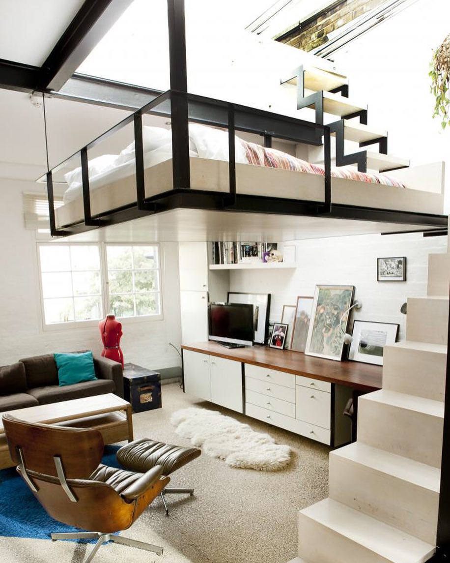 loft bed suspended from the ceiling with steps up to it photo by Instagram user @designwanted
