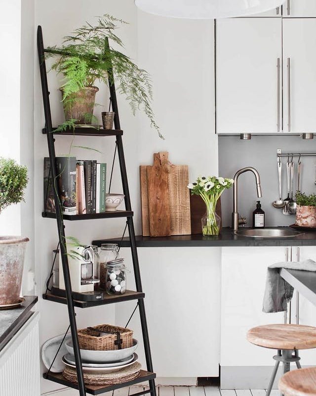 Storage shelf in studio apartment kitchen. Photo by Instagram user @goodhomesmagazine