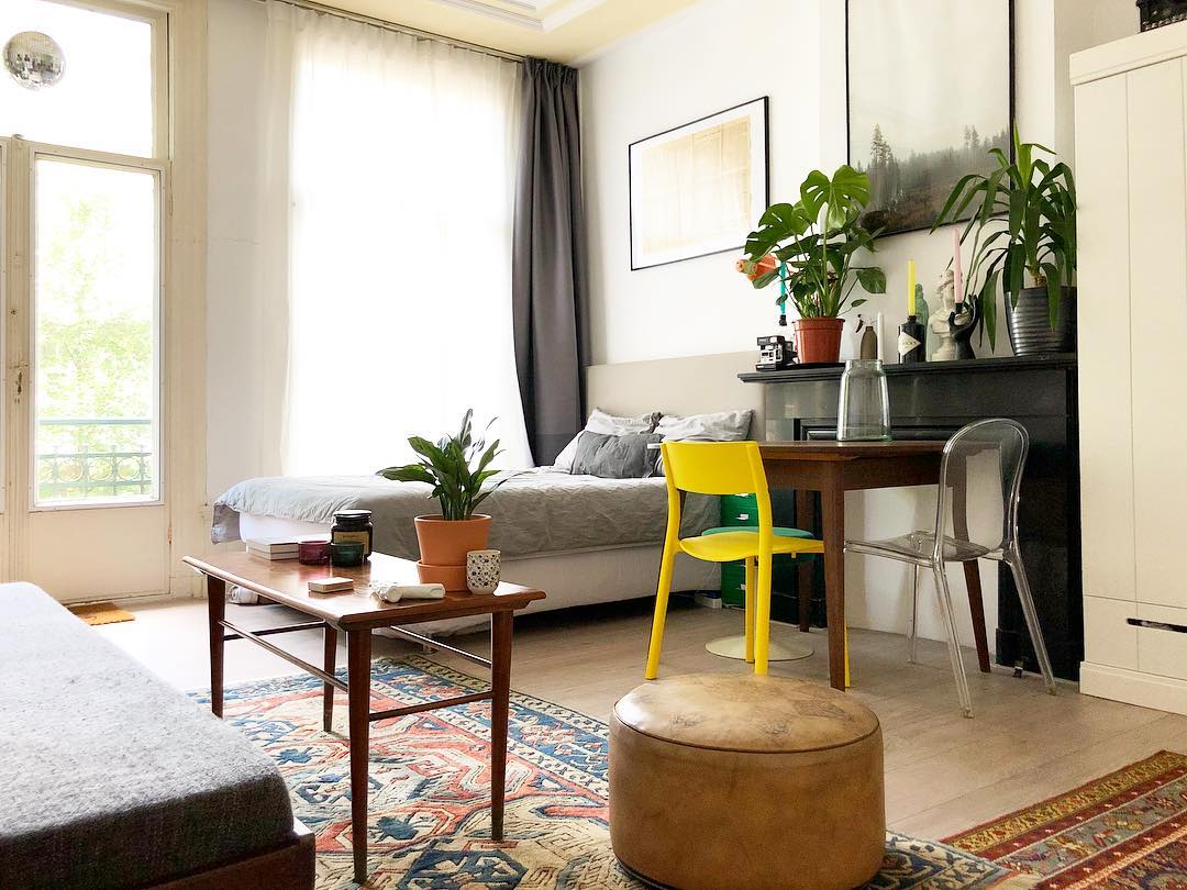 small apartment space with bed and desk next to each other photo by Instagram user @karrrrst