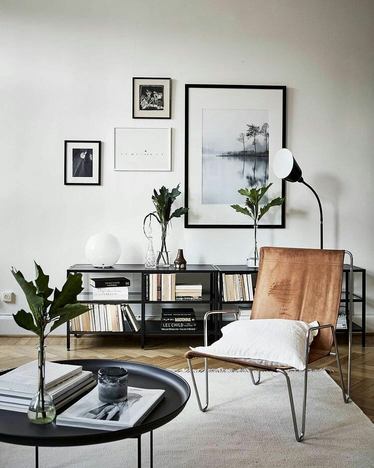 small apartment with exposed leg chair and black furniture photo by Instagram user @ineslarsson