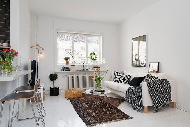 small apartment with statement pieces like white couch and small rugs photo by Instagram user @studio_apartment
