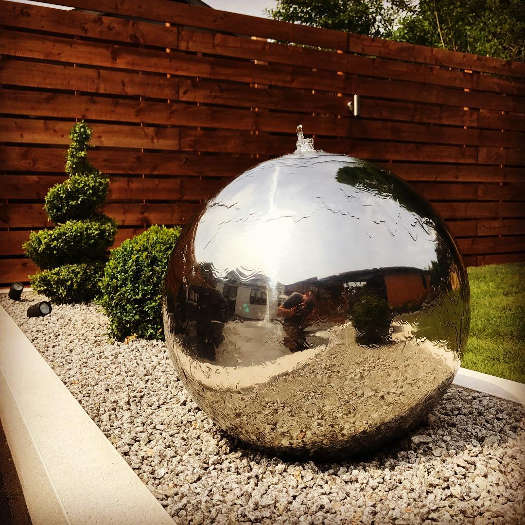 Giant silver sphere backyard fountain. Photo by Instagram user @style_earth