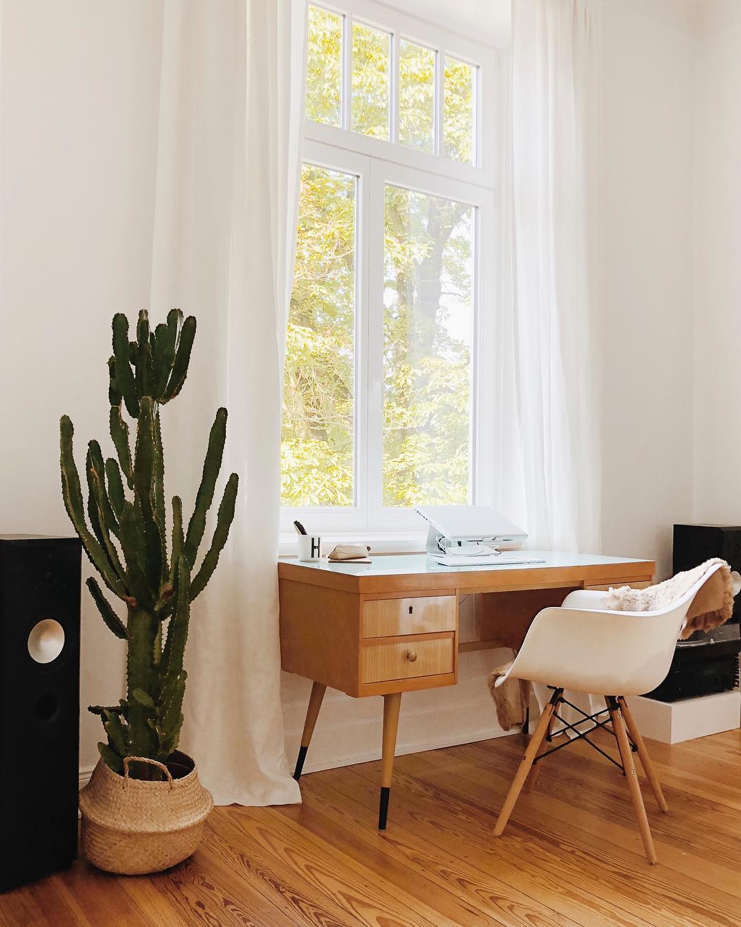 home office with wooden desk and lots of natural light photo by Instagram user @minimal.wohnen