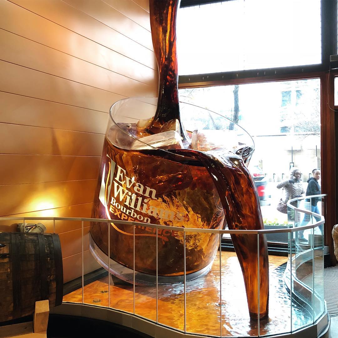 Giant bourbon waterfall with giant glass at Evan Williams. Photo by Instagram user @megatti