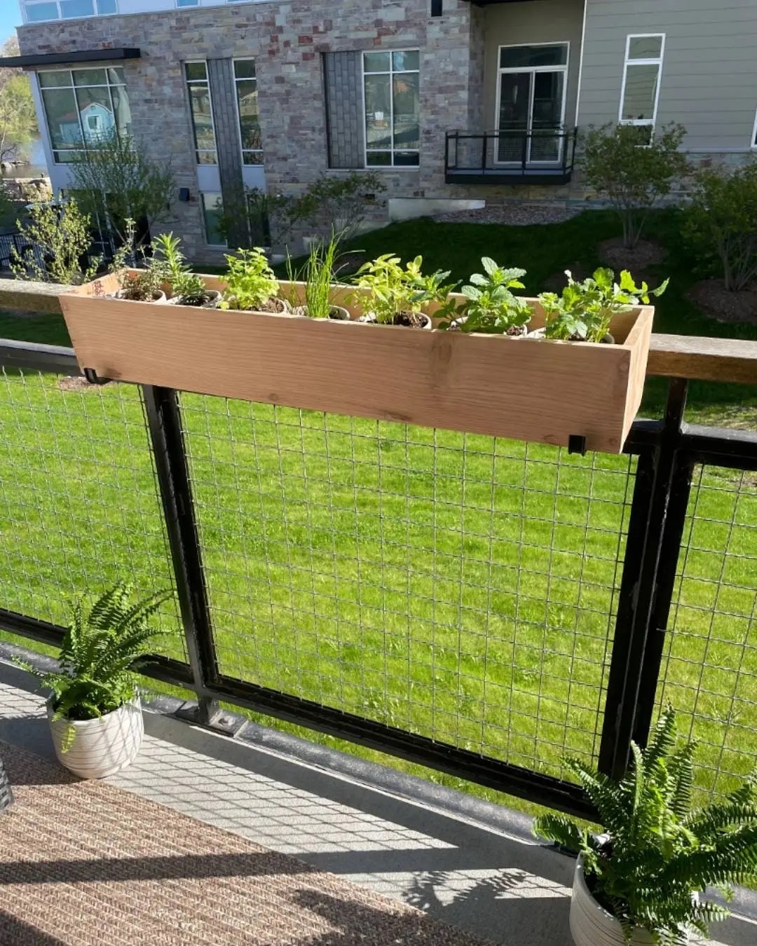 Homemade Railing Planter on an Apartment Balcony. Photo by Instagram user @demeyerwoodcrafts