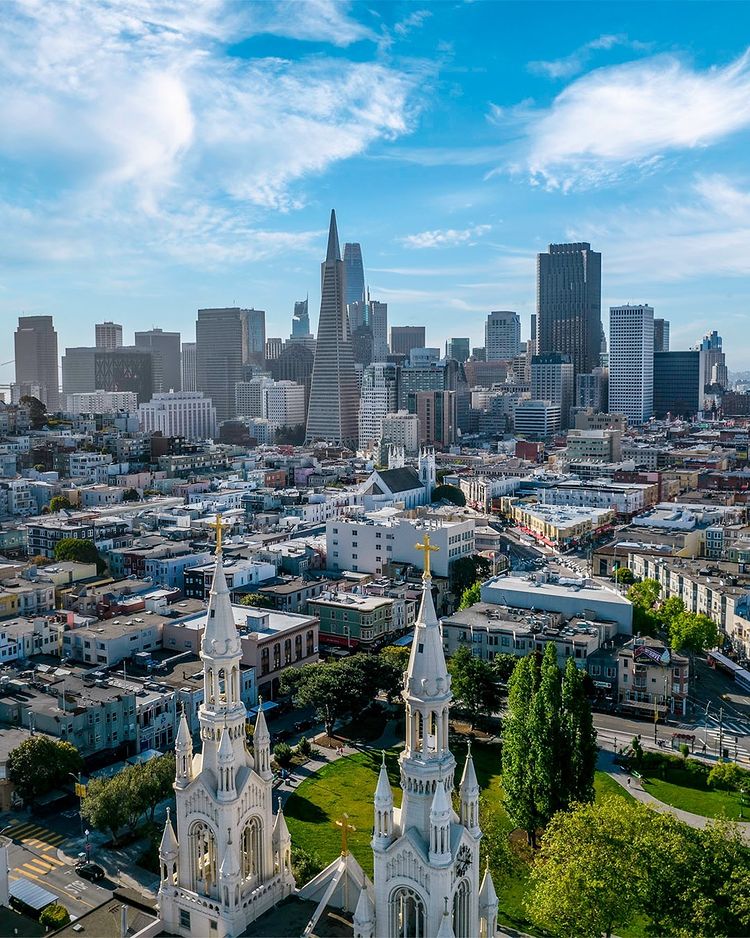 Exterior of the spires of St. Peter and St. Paul Church framing the Transamerica Pyramid in front of San Francisco buildings | Photo by Instagram user @dianebentleyraymond