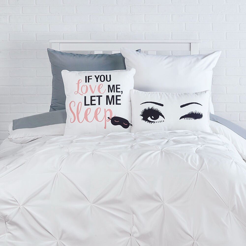Dorm Decor Set Up Bed with Graphic Pillows. Photo by Instagram user @ocmcollegelife