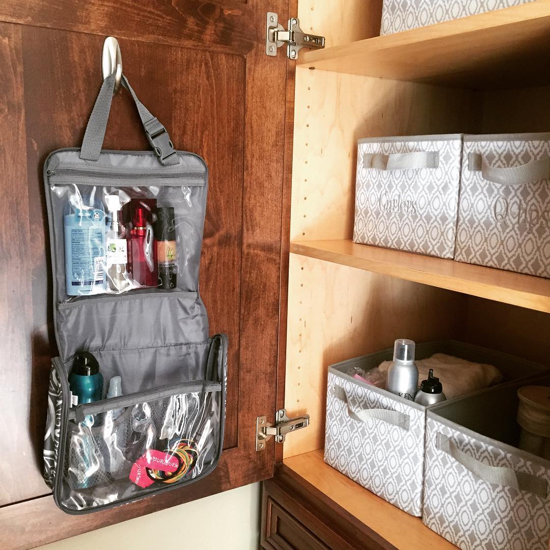Toiletry bag hanging on command hook in cabinet interior. Photo by Instagram user @tiffanyshearobinson