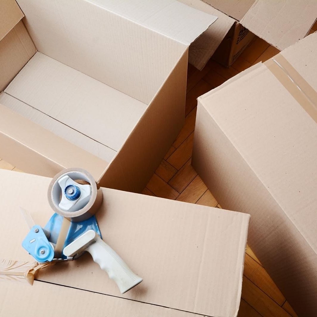 Moving Boxes with a Roll of Tape on Top. Photo by Instagram user @ht_moving_services