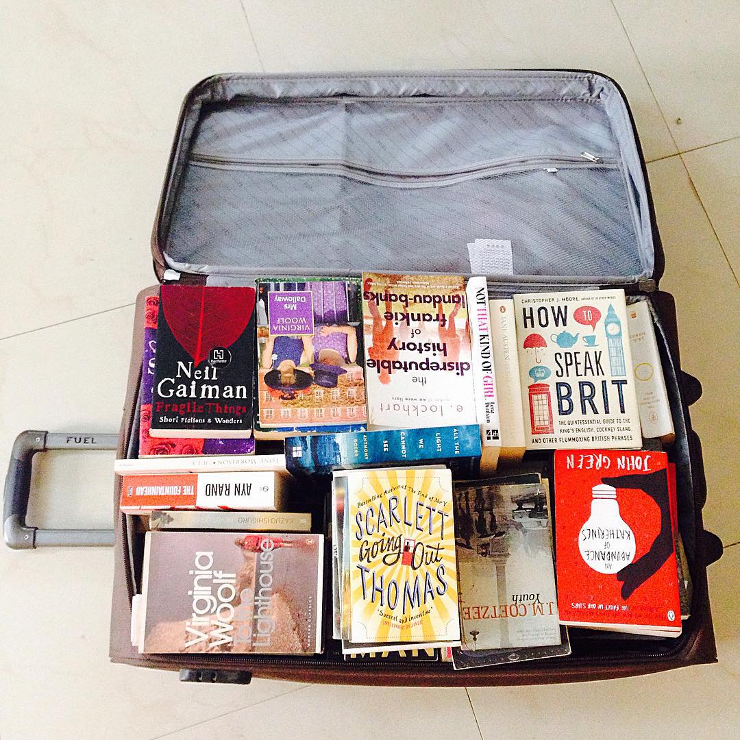 Rolling Suitcase Filled with Books. Photo by Instagram user @darshbob