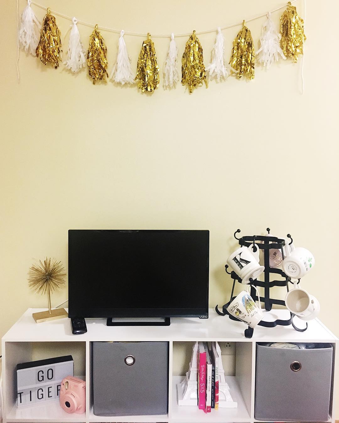 Entertainment center set up in college dorm room. Photo by Instagram user @adashofadrienne