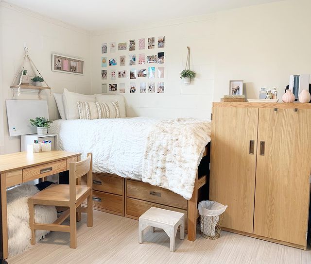 Dorm room with white decor and art on walls Photo via @decor_by_rita