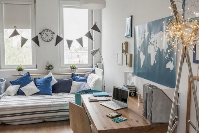 decorated college dorm with twin size bed and office desk