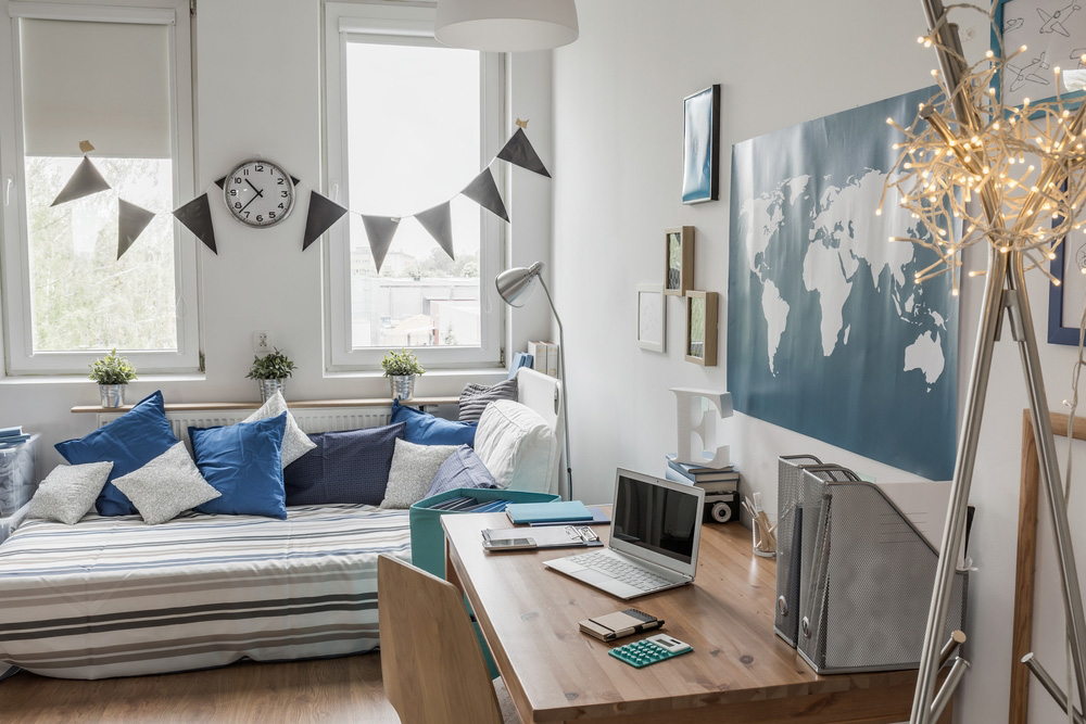 decorated college dorm with twin size bed and office desk