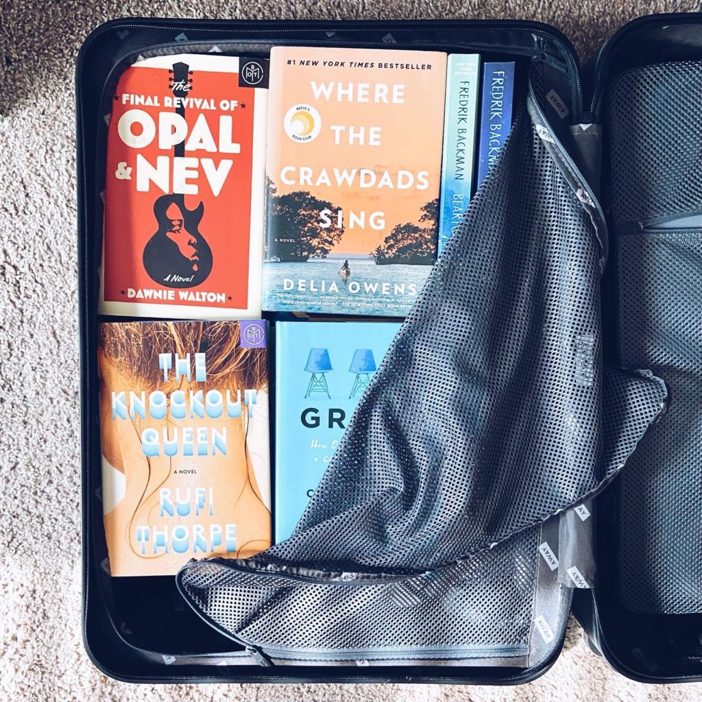 An open suitcase full of books. Photo by Instagram user @mustreadmorris
