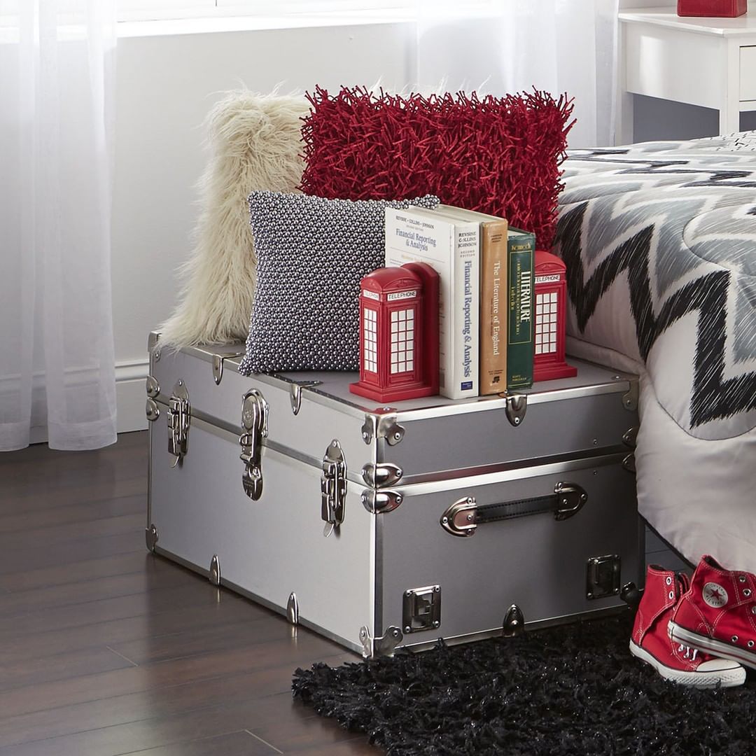 silver trunk at end of bed with decor Photo via @ocmcollegelife