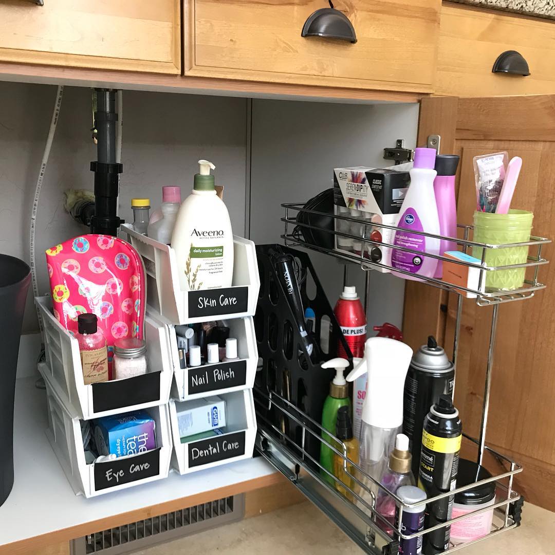 Interior cabinet with stacked bins and rolling organizers. Photo by Instagram user @harmonyorganized