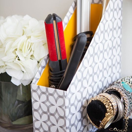 Hair straighteners inside magazine box. Photo by Instagram user @organizerjanet