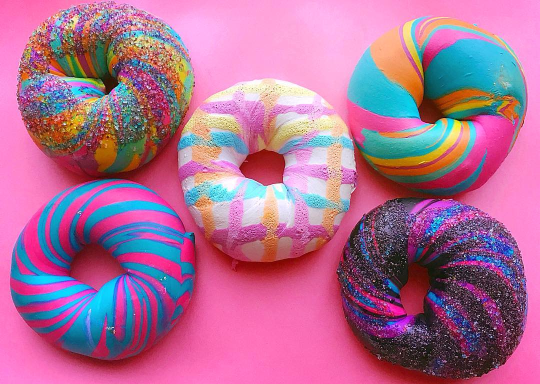 Closeup of five colorful bagels with different designs Photo by Instagram user @thebagelstore