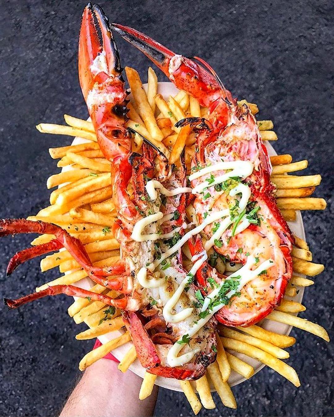 Large plate of fries topped with lobster tails Photo by Instagram user @smorgasburg