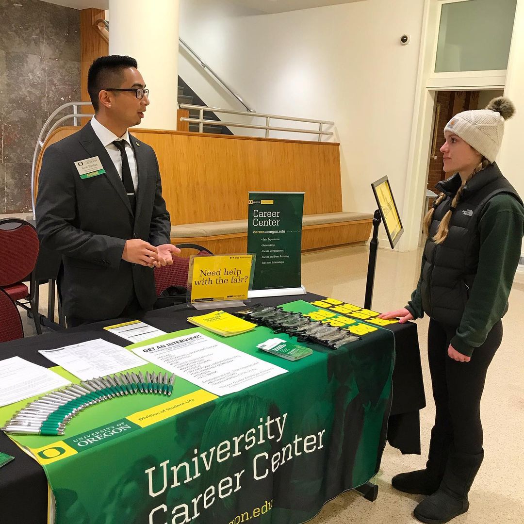 college student speaking with faculty from university career center. Photo via Instagram user @uocareercenter