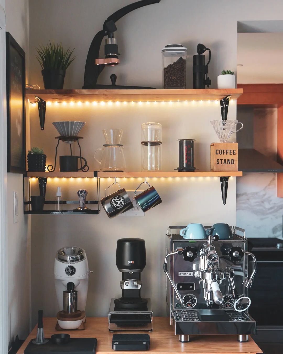 A small coffee bar installed at a wall corner is shown. Photo by Instagram username @bertofcoffee