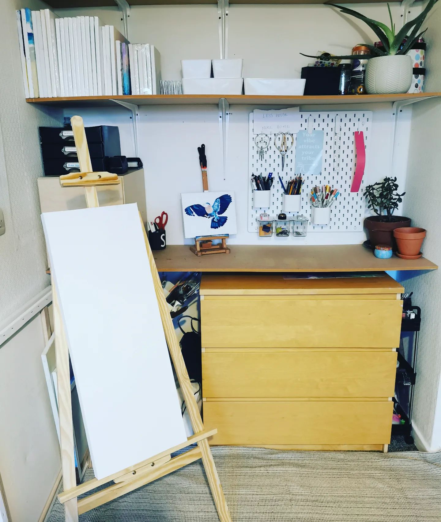 Craft room and art studio with an easel and a pegboard for supplies. Photo by Instagram user @rainbowsbysammy