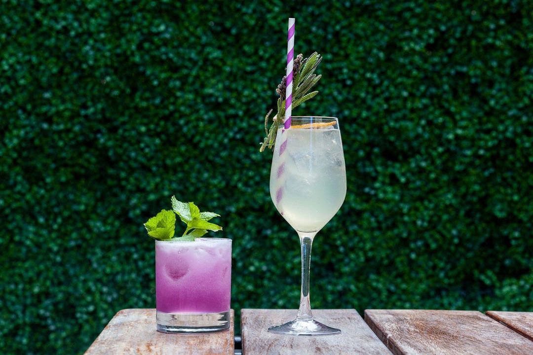 Two craft cocktails on an otudoor table. Photo by Instagram user @biergartenpgh