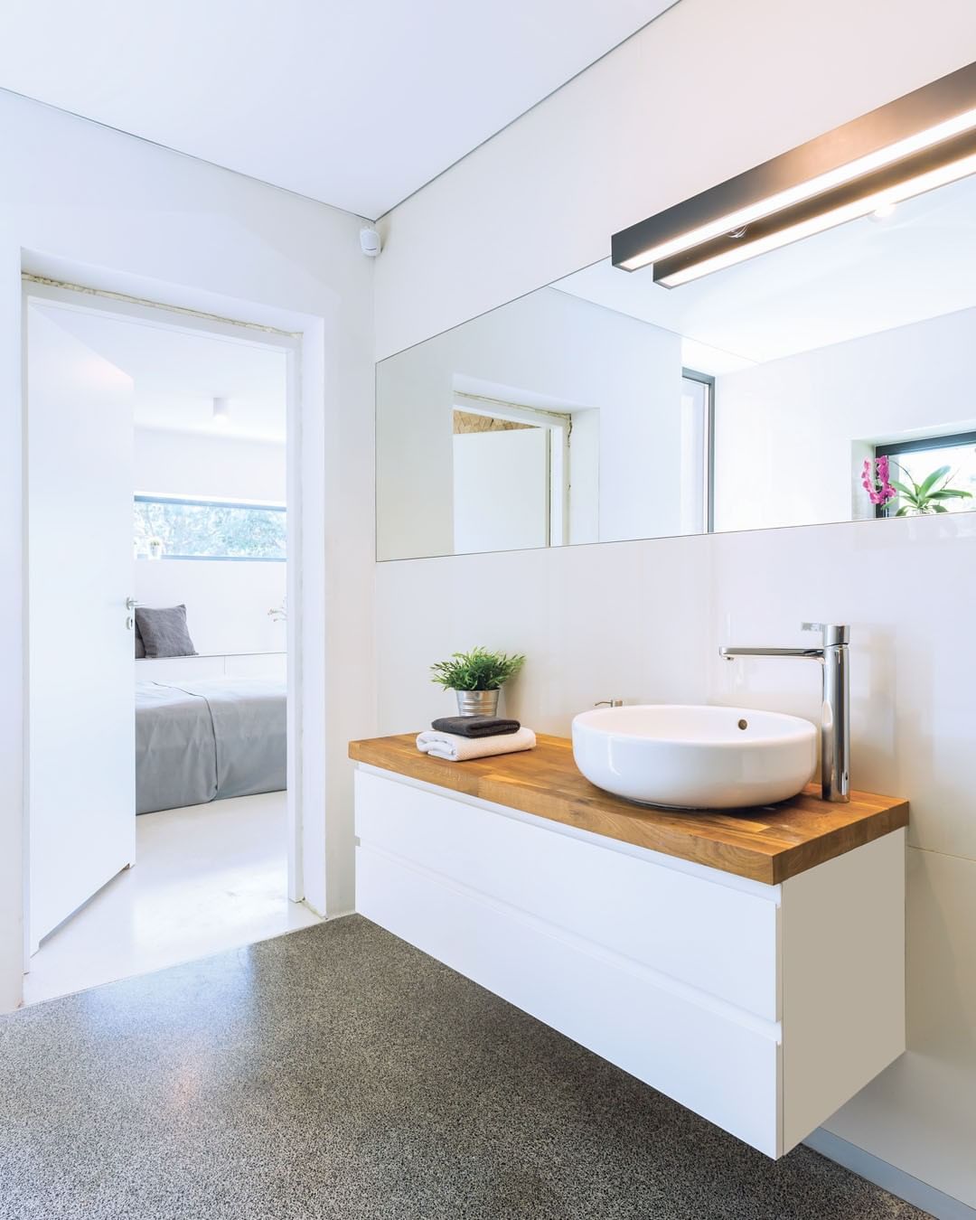 floating vanity with wooden countertop. Photo by Instagram user @spectraworksurfaces