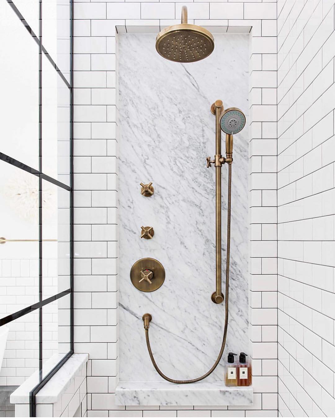 marble shower with gold accessories. Photo via @aprealtyteam