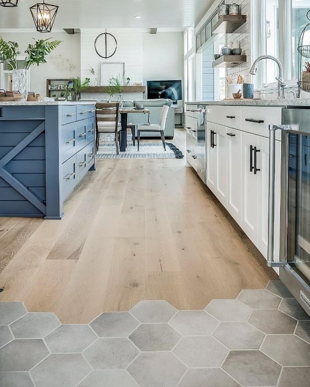A kitchen wooden flooring transitioning to a bee hive tile flooring. Photo by Instagram username @cranberry_design