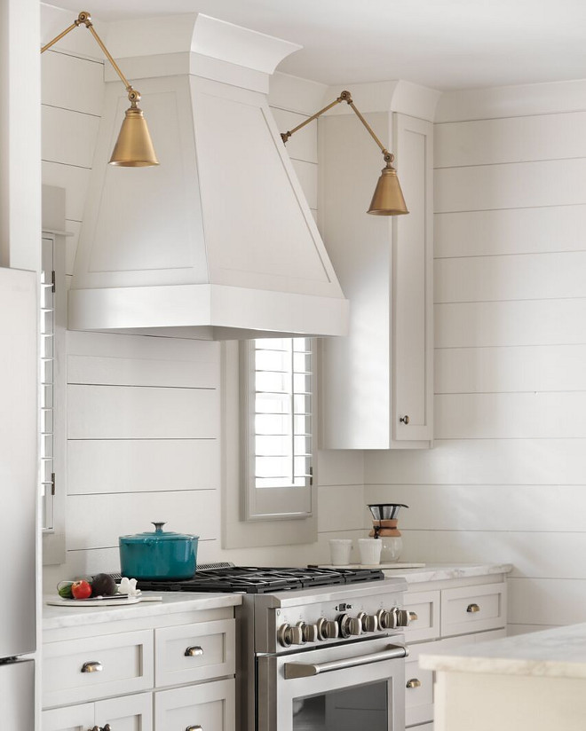 Shown is two hanging lights next to a stovetop hood in a kitchen. Photo by Instagram username @savohouselightiing_