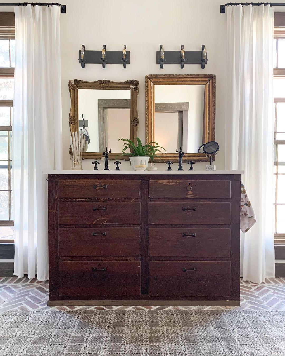 Old dresser repurposed into a double sink vanity. Photo by Instagram user @thecolonialfarmhouse