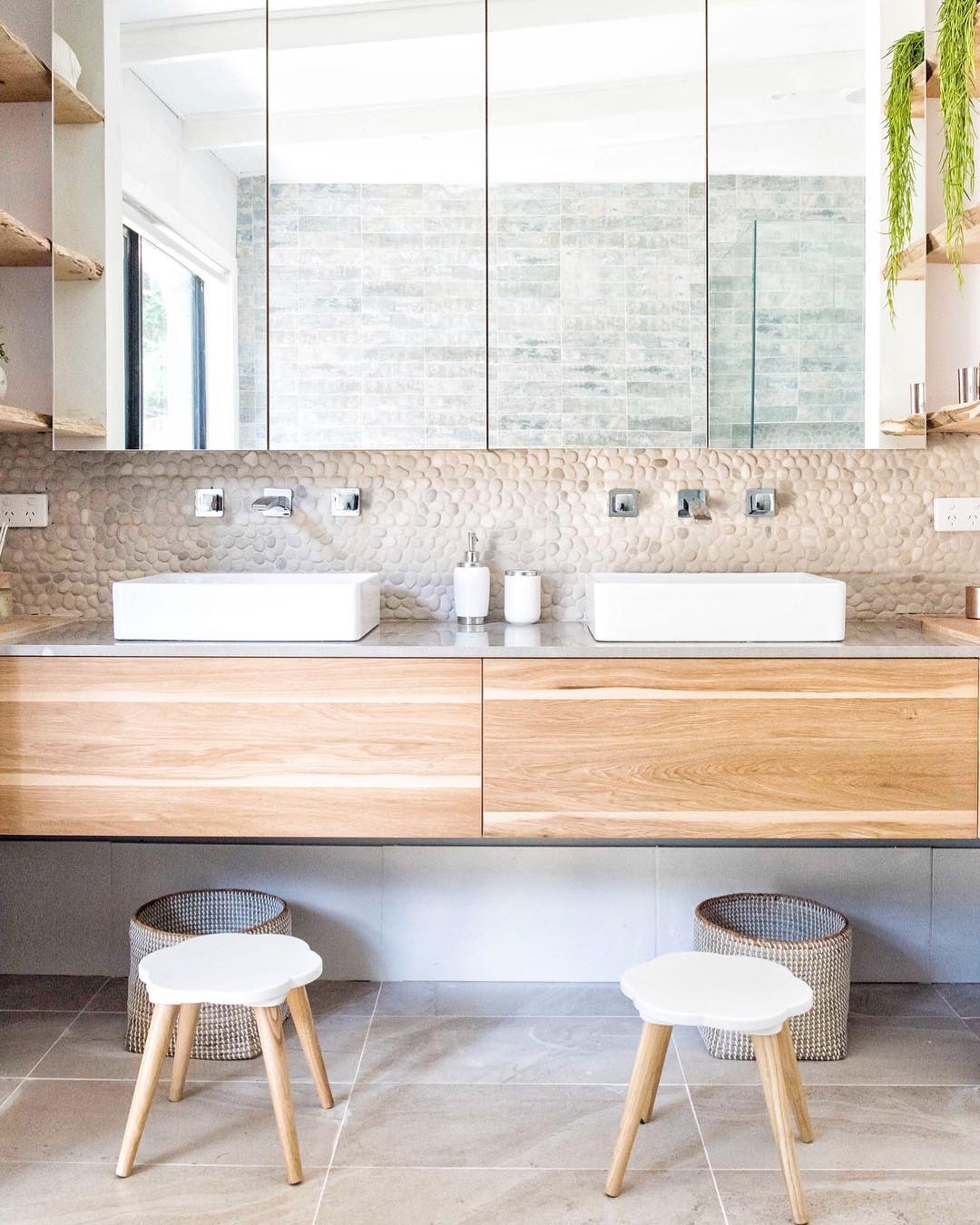 his and hers sinks on a floating vanity and stools photo by Instagram user @tlcinteriors