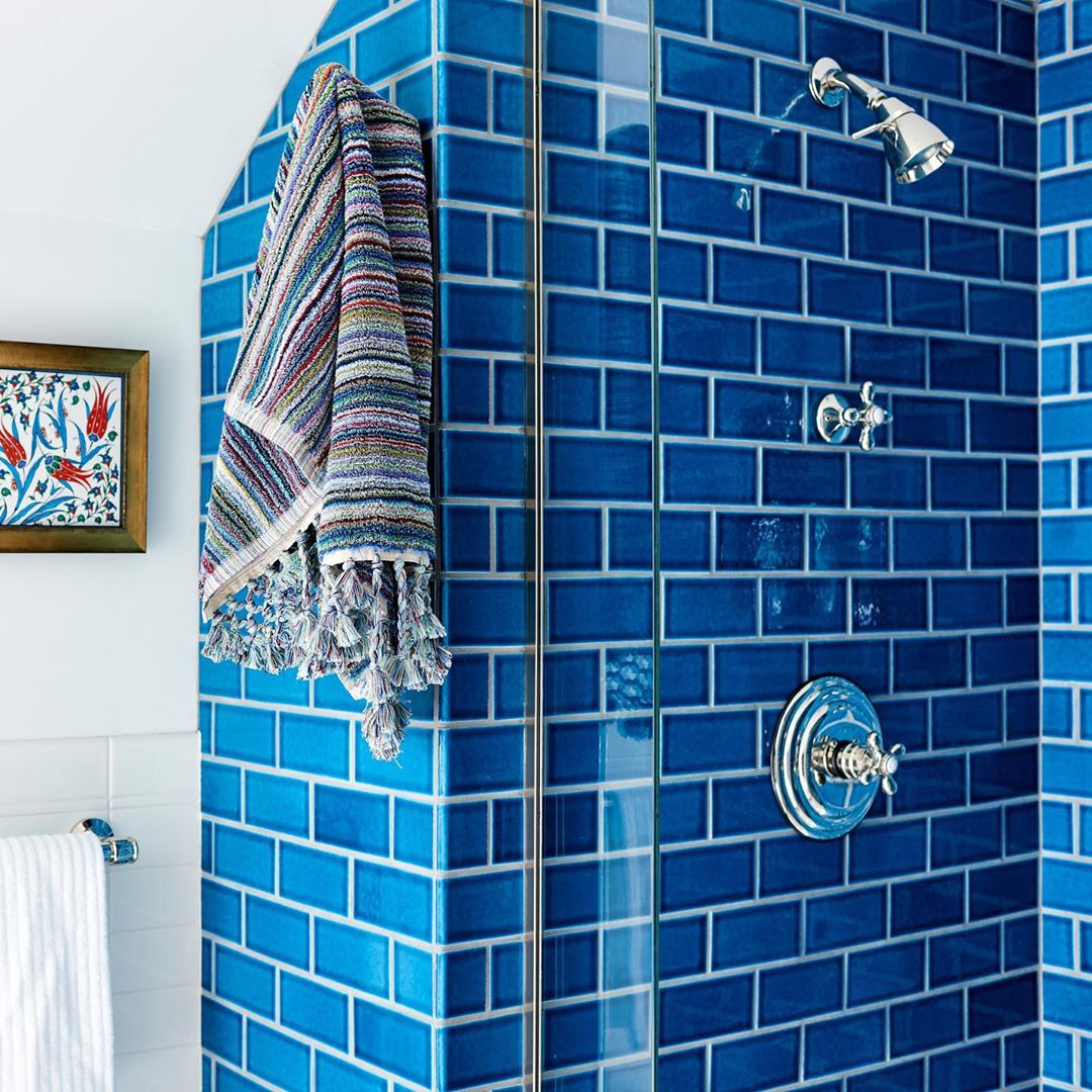 blue subway tile in shower with towel hanging photo by Instagram user @fireclaytile