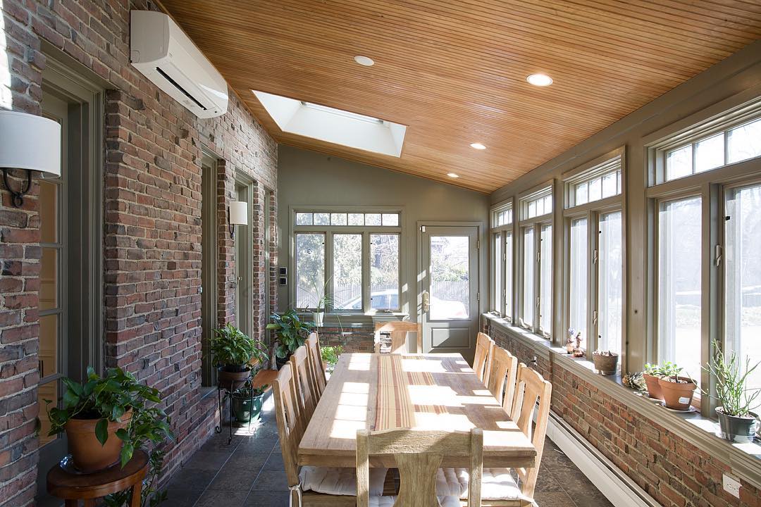 Sunroom with brick interior. Photo by Instagram user @michaelkimassociates